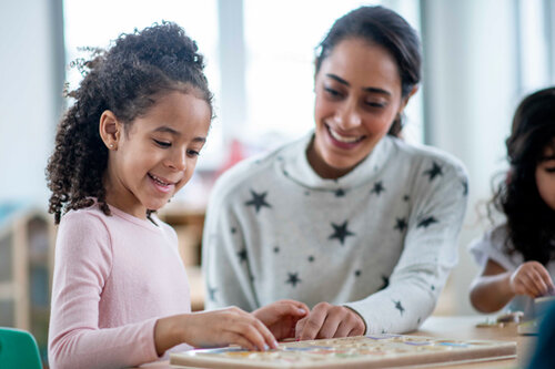 A teacher helping a child