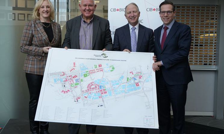 Mayor Scarpitti and MDE staff holding a map.