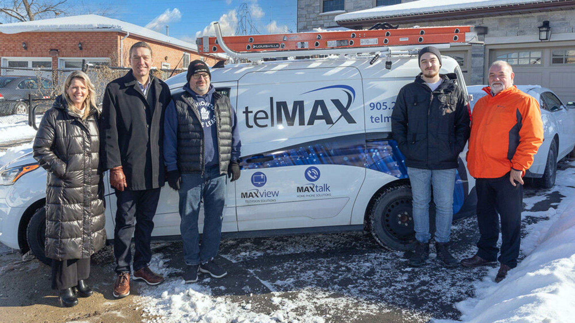 Mayor Taylor standing beside a telMAX van
