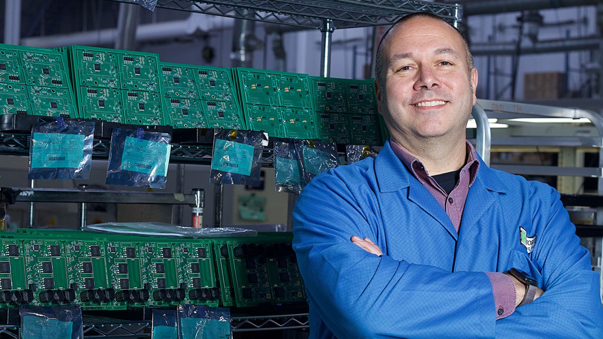 Microart Employee standing in front of microchips