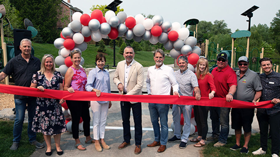 Group of people standing together at a ribbon cutting event