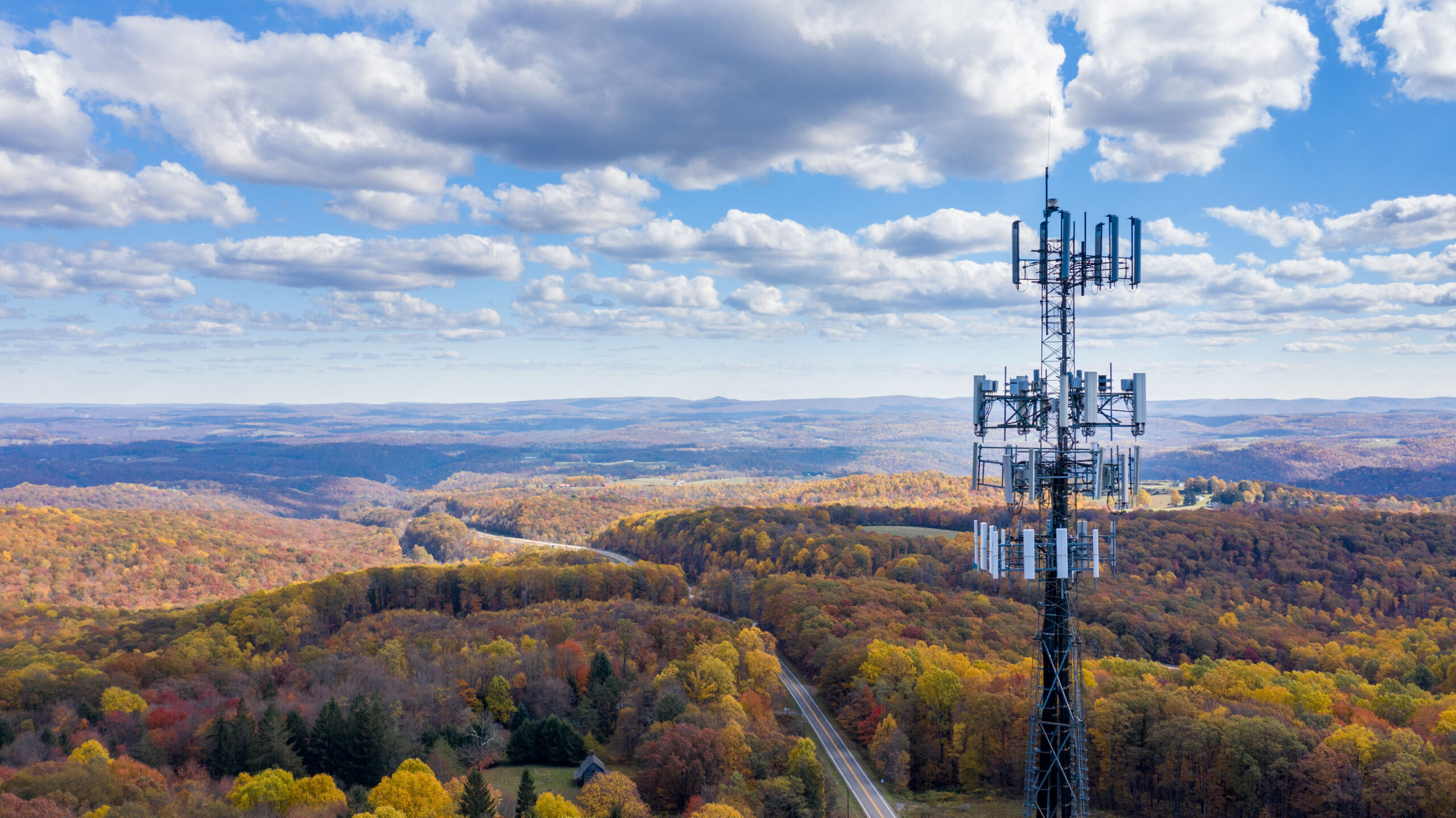 Aerial view of mobiel phone cell tower over forested rural area