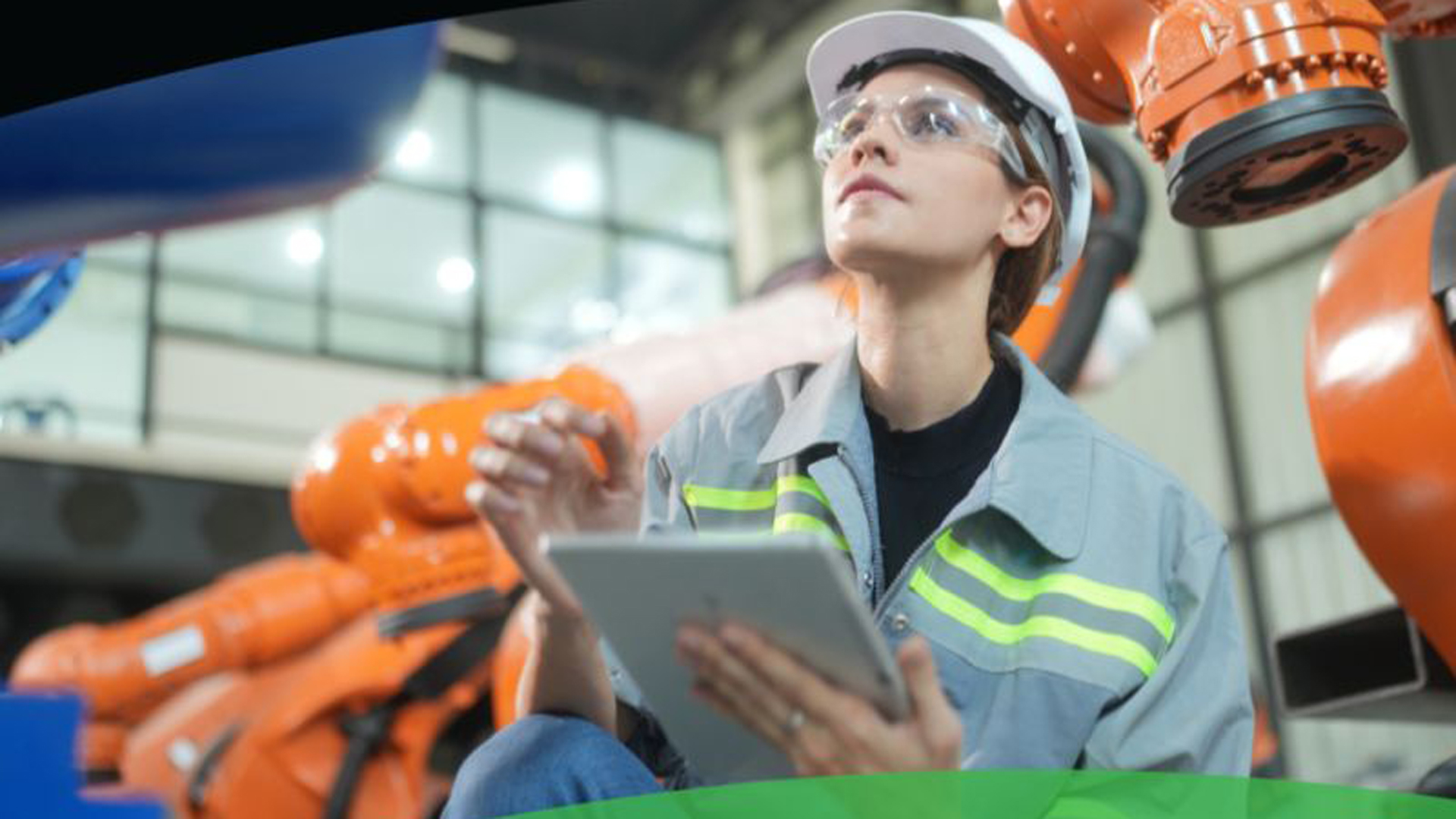 Person working in front of robots in manufacturing facility
