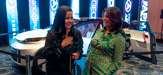 Two professionals having a conversation in front of Project Arrow