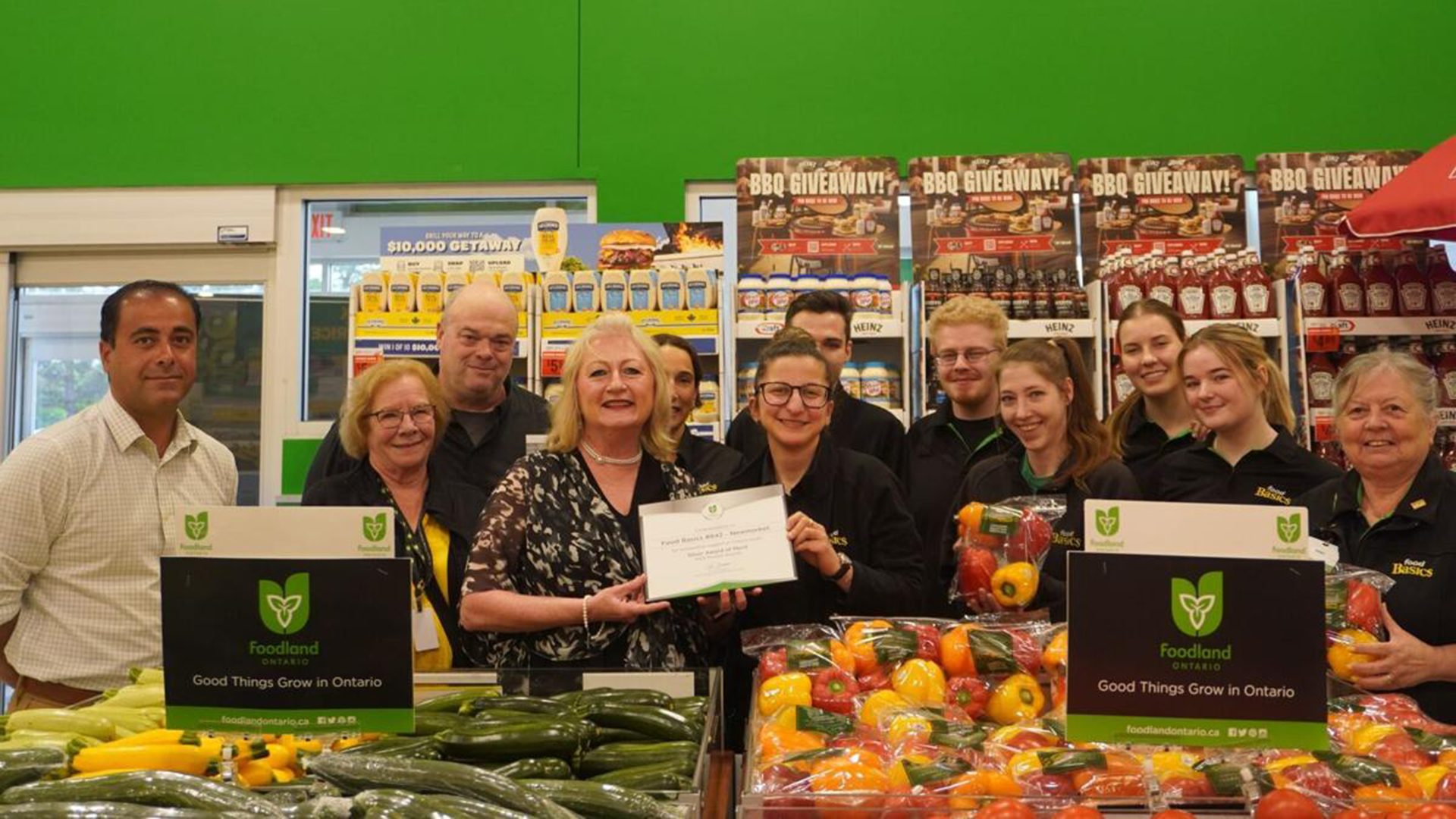 Alessia Trotta, of Newmarket’s Food Basics, is from one of three local grocers to be honoured by Foodland Ontario. Trotta (centre) accepts the award from Newmarket-Aurora MPP Dawn Gallagher Murphy.